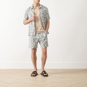Model wearing Samsoe & Samsoe Salute Symmetry casual shirt with matching shorts and dark slide sandals.