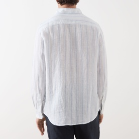 Model wearing Samsoe & Samsoe Ryan Striped Shirt in Clear Blue St., rear view showing neck yoke seam, long sleeves and curved hemline.