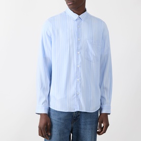 Model wearing Samsoe & Samsoe Ryan Stripe Shirt in Windsurfer St., light blue vertical stripes, chest pocket, long sleeves, styled with blue jeans.
