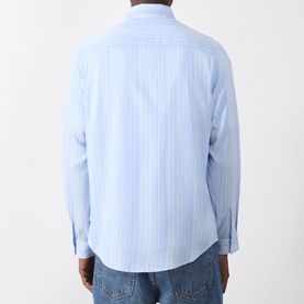 Model wearing Samsoe & Samsoe Ryan Stripe Shirt in Windsurfer St., showing back view with curved hemline and neck yoke seam, styled with blue jeans.