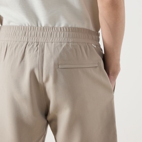 Model wearing Samsoe & Samsoe Smith Lightweight Shorts in Aluminium, showing elasticated waistband and zipped rear pocket detail.