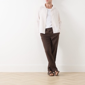 Model wearing Samsoe & Samsoe Jabari Casual Trousers in Turkish Coffee linen, styled with a white shirt and brown sandals.