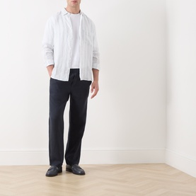 Model wearing Samsoe & Samsoe Jabari Casual Trousers in Salute, styled with a white linen shirt and black loafers.