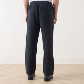 Model wearing Samsoe & Samsoe Jabari Casual Trousers in Salute, showing rear view with patch pockets and elasticated waistband