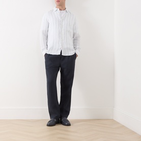 Model wearing Samsoe & Samsoe Jabari Casual Trousers in Salute, slim-leg linen, styled with a white shirt and black leather shoes.