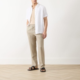 Model wearing Samsoe & Samsoe Jabari Regular-Fit Trousers in Aluminium linen, styled with a white short-sleeve shirt and black sandals.