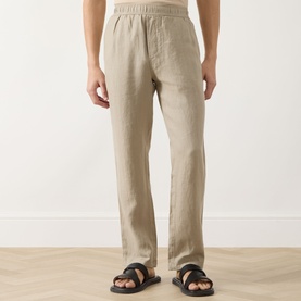 Model wearing Samsoe & Samsoe Jabari Regular-Fit Trousers in Aluminium linen, styled with black leather sandals