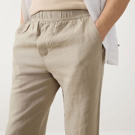 Model wearing Samsoe & Samsoe Jabari Regular-Fit Trousers in Aluminium linen, elasticated waistband, straight leg, paired with white shirt