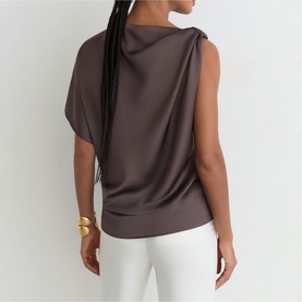 Model wearing Reiss purple draped sleeveless top, back view, styled with white trousers and gold cuff bracelet.