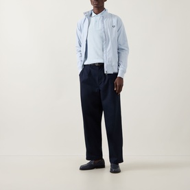 Model wearing Fred Perry Dusky Blue casual jacket, styled with navy trousers and black loafers.