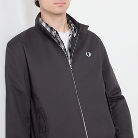 Model wearing Fred Perry Laurel Wreath Harrington Jacket in Anchor Grey, zip fastening, mock neck, styled over checked shirt.