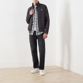 Model wearing Fred Perry Laurel Wreath Harrington Jacket in Anchor Grey, styled with gingham shirt, dark jeans and white trainers.