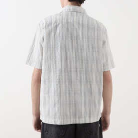 Model wearing Fred Perry Seersucker Check Shirt in Ecru, rear view, short sleeves, two-tonal check pattern on breathable seersucker fabric.