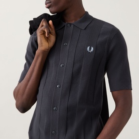 Model wearing Fred Perry Anchor Grey cotton knit casual shirt with button placket, vertical ribbed texture and embroidered laurel wreath logo