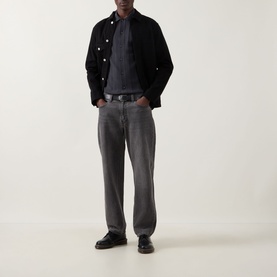 Model wearing Fred Perry Anchor Grey casual shirt, styled with black jacket, grey jeans and black leather shoes.