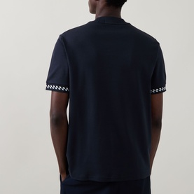 Model wearing Fred Perry Navy Crew Neck T-shirt, rear view, with checkerboard print trim detail on short sleeves.