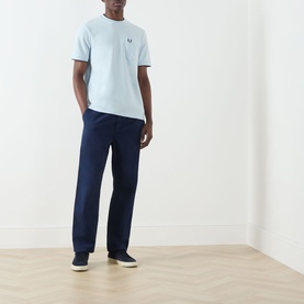 Model wearing Fred Perry Light Ice Crew Neck T-shirt, styled with navy straight-leg trousers and dark canvas shoes.