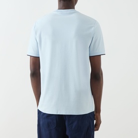 Model wearing Fred Perry Light Ice cotton crew neck T-shirt, back view, with navy tipping detail at collar and cuffs.