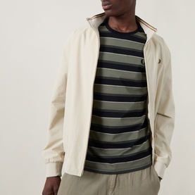 Model wearing Fred Perry Black Crew Neck T-Shirt styled with a stone zip-up harrington jacket and khaki trousers.