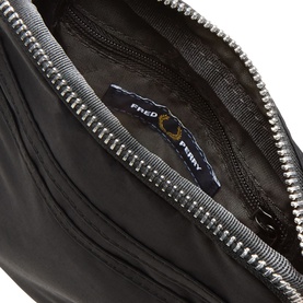 Fred Perry Brentham Small Crossbody Bag in black, open interior view showing branded label and silver-tone zip hardware