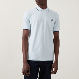 Model wearing Fred Perry Laurel Logo Crepe Piqu&eacute; Polo Shirt in Light Ice with twin tipped detailing and chest Laurel Wreath logo, styled with dark