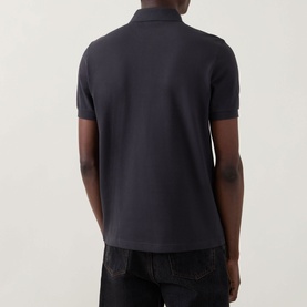 Model wearing Fred Perry Twin Tipped Polo Shirt in Anchor Grey, rear view, short sleeves, straight hem, styled with dark jeans.
