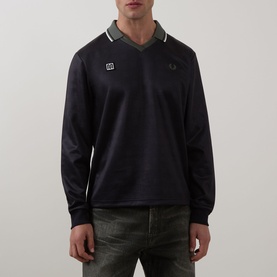 Model wearing Fred Perry Meyba Long-Sleeve T-Shirt in Black with V-neck collar, long sleeves, ribbed cuffs and laurel wreath logo patch