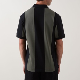 Model wearing Fred Perry Meyba Cut & Sew Polo Shirt in black with khaki vertical panel detail, short sleeves, shown from the back.
