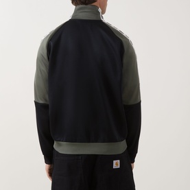 Model wearing Fred Perry Meyba Taped Track Jacket in Black, two-tone with khaki panels, zip-through, rear view shown
