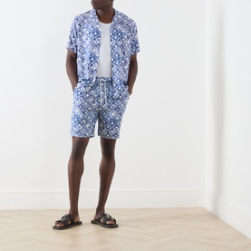 Model wearing Scotch & Soda Tiles Flower casual shirt in blue tile print, styled with matching shorts and brown sandals