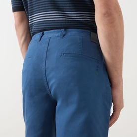 Model wearing Scotch & Soda Ensign Blue chino shorts, rear view showing back pocket and waistband detail
