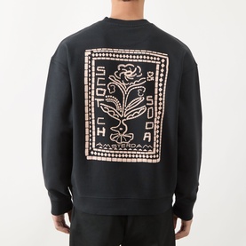 Model wearing Scotch & Soda Floral Graphic Logo Sweatshirt in Meteorite with oversized floral logo graphic on back, crew neck, ribbed trims