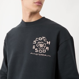 Model wearing Scotch & Soda Floral Graphic Logo Sweatshirt in Meteorite, crew neck with rose graphic logo print on chest