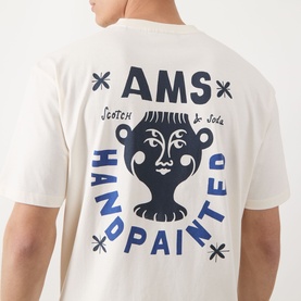 Model wearing Scotch & Soda Artwork Logo T-Shirt in Eggnog, back view showing AMS Hand Painted graphic print in navy blue.