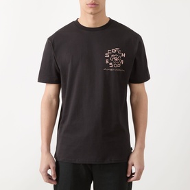 Model wearing Scotch & Soda Floral Graphic T-Shirt in Meteorite, featuring crew neck and small chest logo graphic, styled with black trousers.