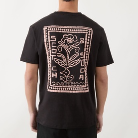 Model wearing Scotch & Soda Floral Graphic T-Shirt in Meteorite black, showing enlarged pink floral logo graphic on the back