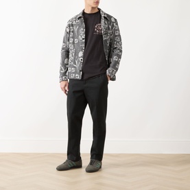 Model wearing Scotch & Soda Floral Graphic T-Shirt in Meteorite, styled with monochrome printed jacket and black trousers