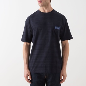 Model wearing Scotch & Soda Logo Texture Jacquard Stripe T-Shirt in Sky Captain, featuring subtle stripes, logo patch, and round neck. Styled with