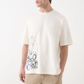 Model wearing Scotch & Soda Work-Out Art Logo T-Shirt in Eggnog. Oversized fit, bird graphic print, round neck, short sleeves.