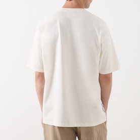 Model wearing Scotch & Soda Work-Out Art Logo T-Shirt in Eggnog, rear view showing relaxed fit, short sleeves and straight hemline