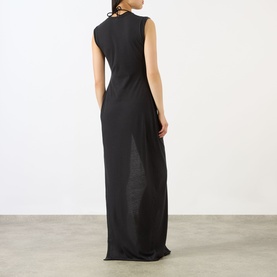 Model wearing Skims Sarong Dress in Onyx, sleeveless floor-length black maxi with open back detail, shown from behind