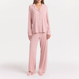 Model wearing Skims Morganite pyjamas, long-sleeve button-up top with chest pocket and wide-leg trousers