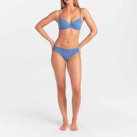 Model wearing Skims Arctic blue thong with matching underwired bra in smooth fabric