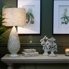 Mindy Brownes Grace Textured Table Lamp in ivory ceramic with linen shade, styled on a console table with decorative objects and framed botanical