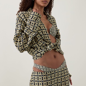 Model wearing Away That Day Navy/Gold Link Print bikini brief styled with matching print crop shirt and mini skirt