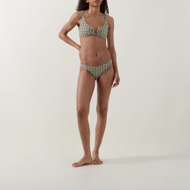Model wearing Away That Day navy/gold link print bikini top with matching briefs, shown in full-length front-facing shot