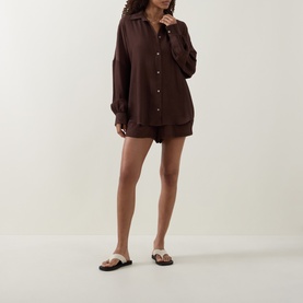 Model wearing Away That Day brown cover up shirt and matching shorts, styled with brown flat sandals