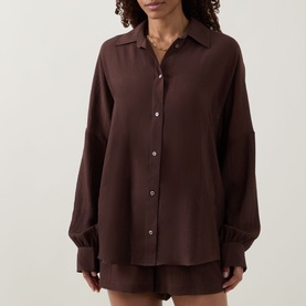 Model wearing Away That Day brown relaxed-fit shirt cover-up with button front, long sleeves, and matching brown shorts.