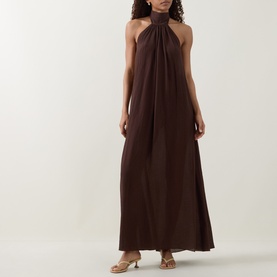 Model wearing Away That Day Espresso Crinkle Linen Dress with gathered halterneck and maxi length, styled with tan sandals