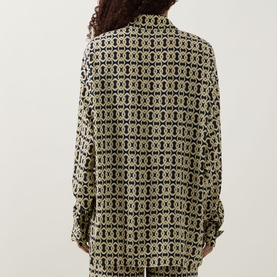 Model wearing Away That Day cover up in Navy/Gold Link Print, rear view, relaxed long-sleeve silhouette with matching trousers.